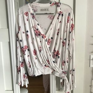 White wrap top with flowers and flare sleeves